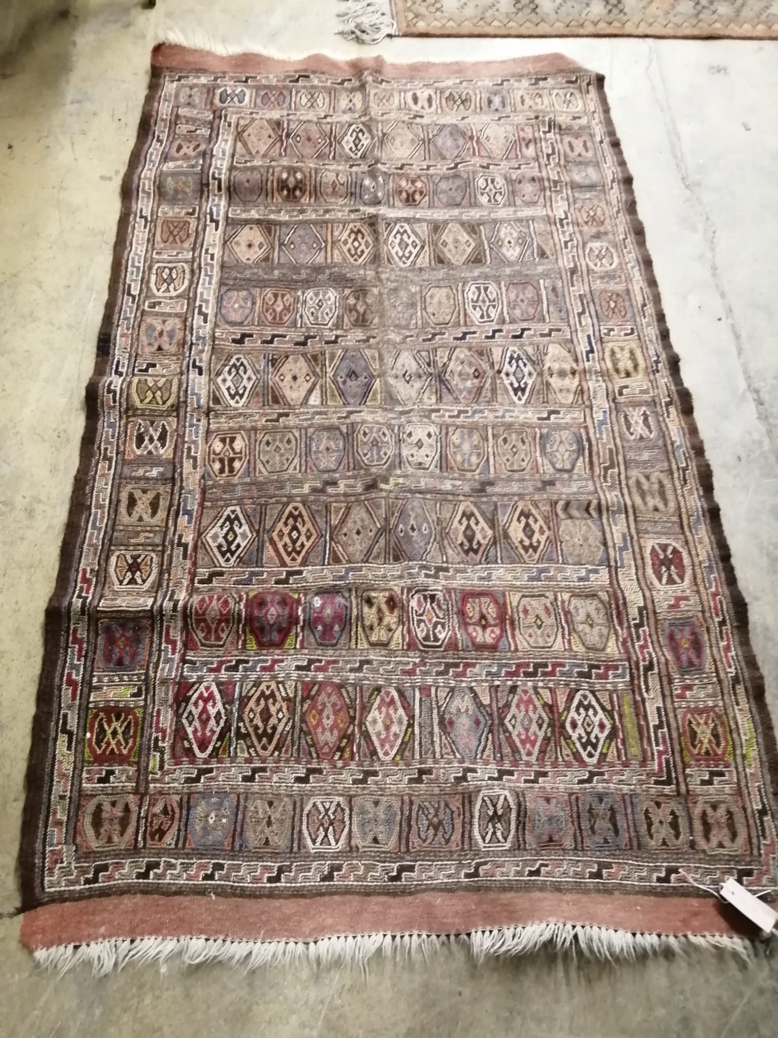 A flat weave polychrome rug, 180 x 106cm